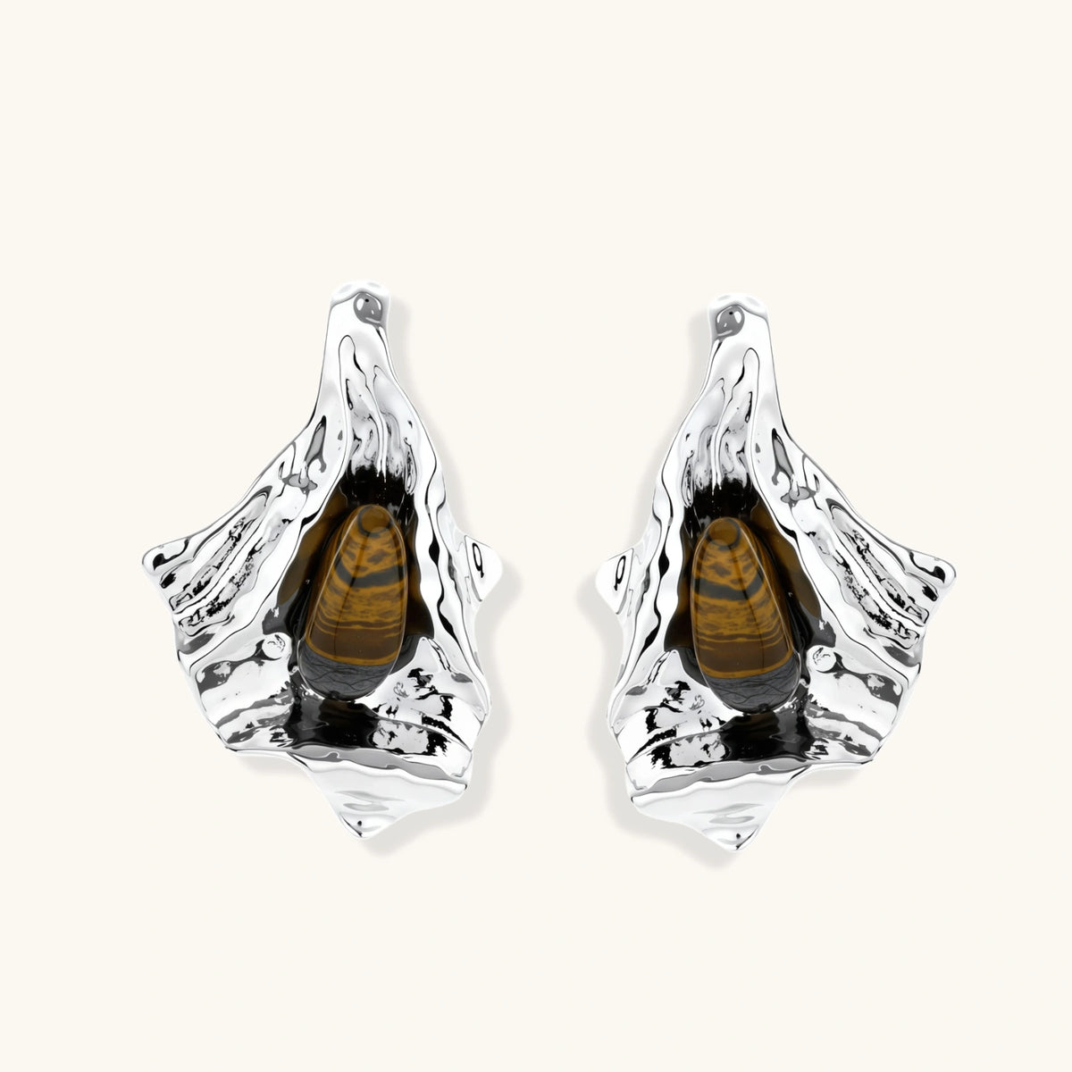 Silver sculptural earrings with flowing molten forms and amber gemstones, featuring 925 silver posts on white background.