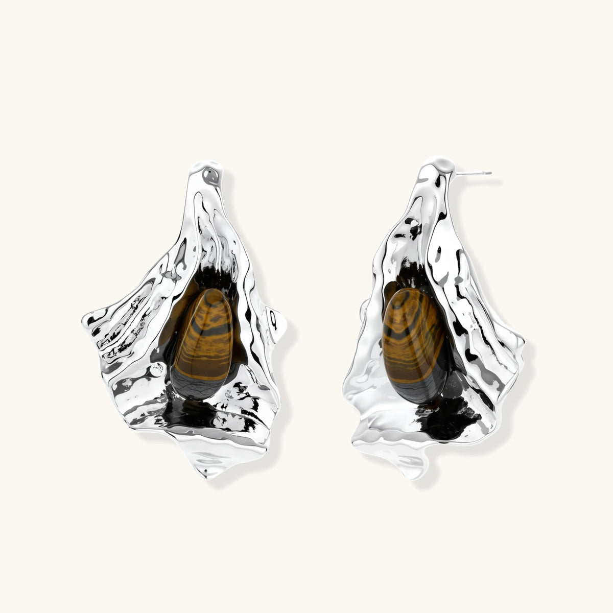 Silver sculptural earrings with flowing molten forms and amber gemstones, featuring 925 silver posts on white background.