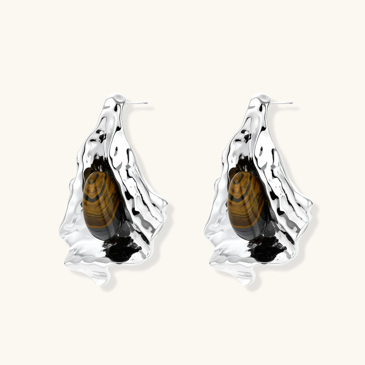 Silver sculptural earrings with flowing molten forms and amber gemstones, featuring 925 silver posts on white background.