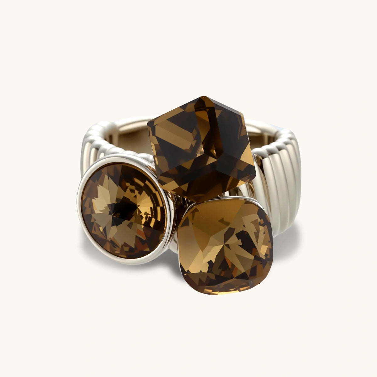 Silver-plated adjustable cocktail ring featuring three golden-brown zirconia stones in mixed cuts on textured band