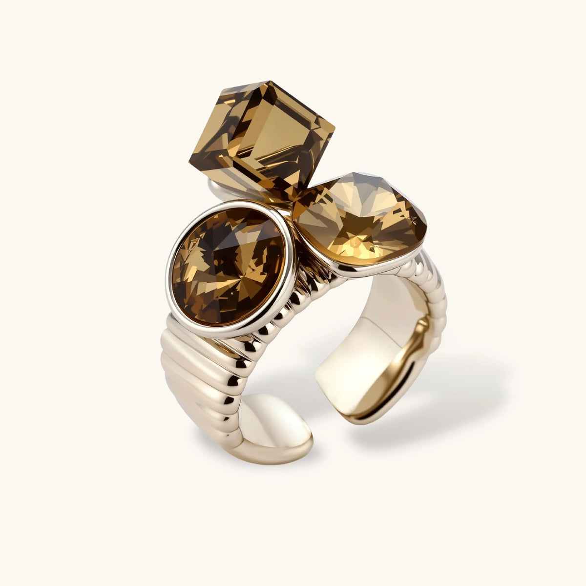 Silver-plated adjustable cocktail ring featuring three golden-brown zirconia stones in mixed cuts on textured band